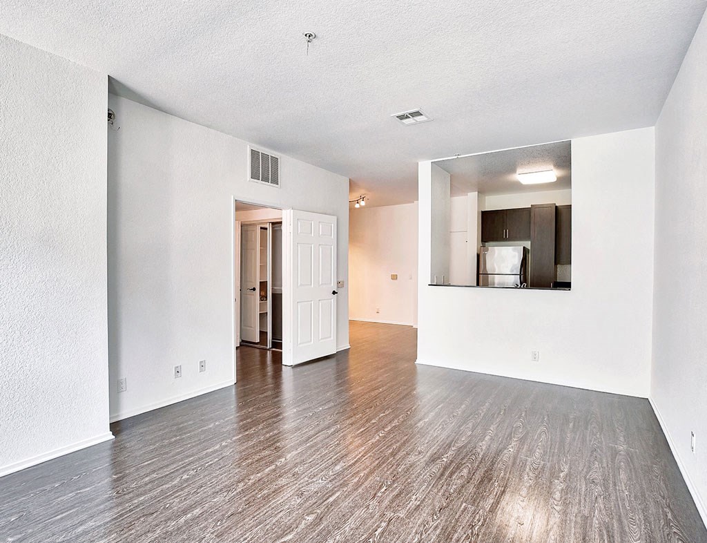 Interior an empty living room with white walls and wood flooring