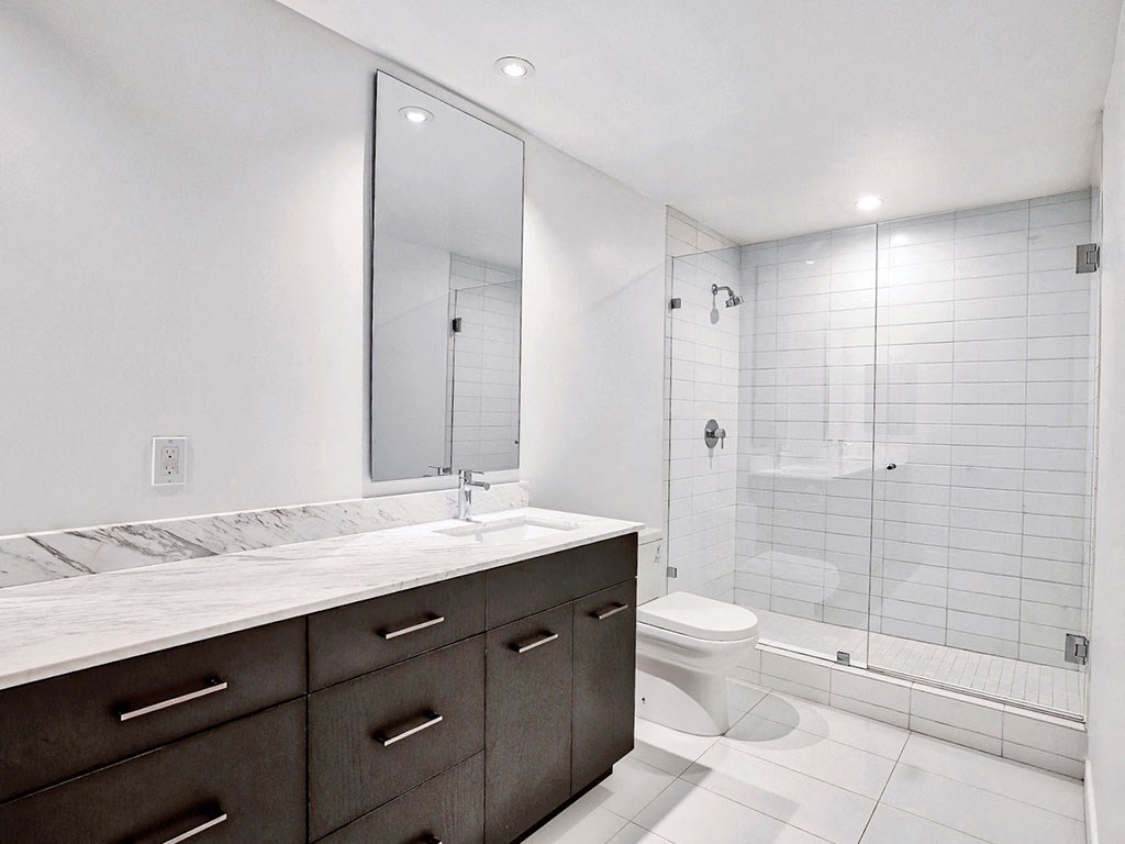 an image of a bathroom with a shower and a sink