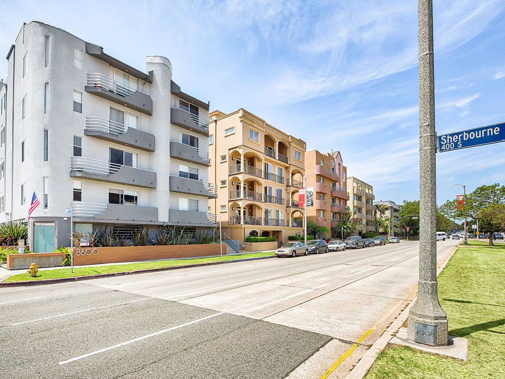 a view of a street with apartments on the side of the road
