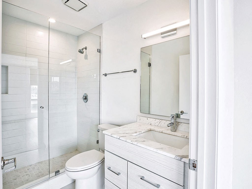 a bathroom with a sink toilet and a shower