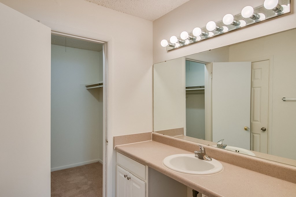 an empty bathroom with a sink and a mirror