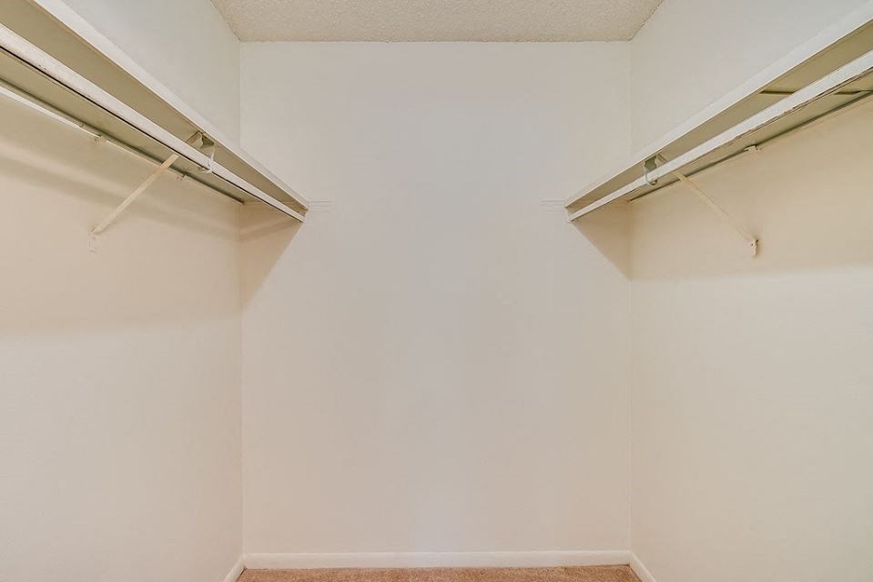 an empty room with white walls and fluorescent lights on the wall