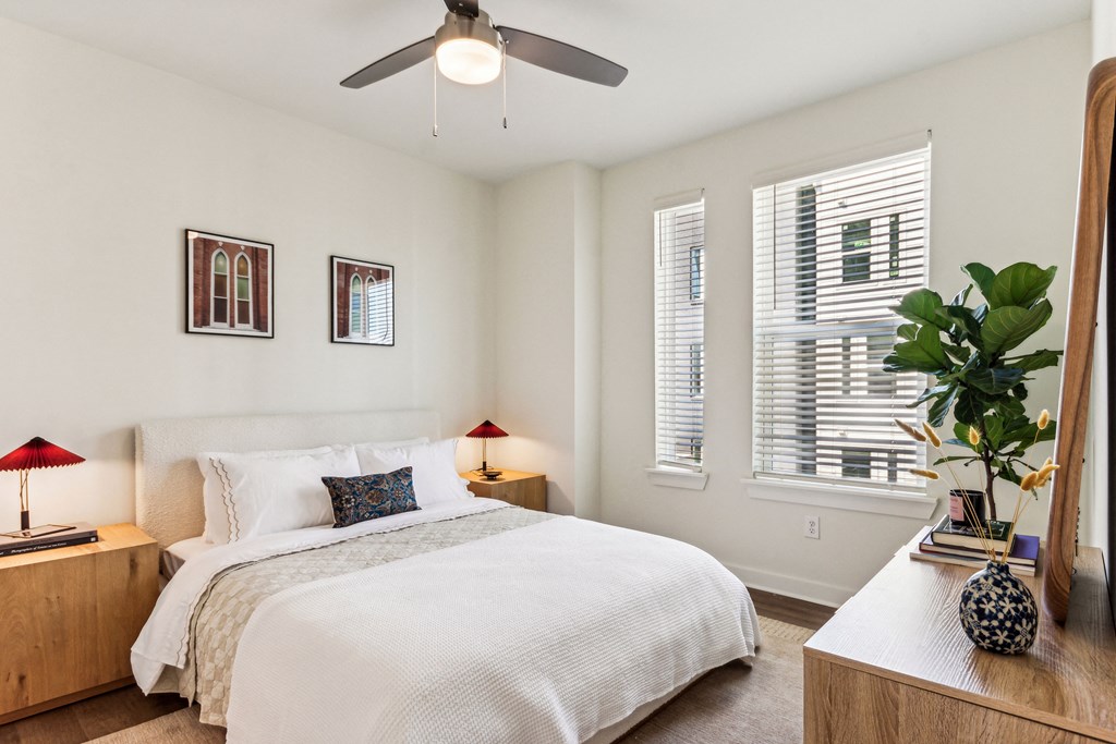 a bedroom with a large bed and a ceiling fan