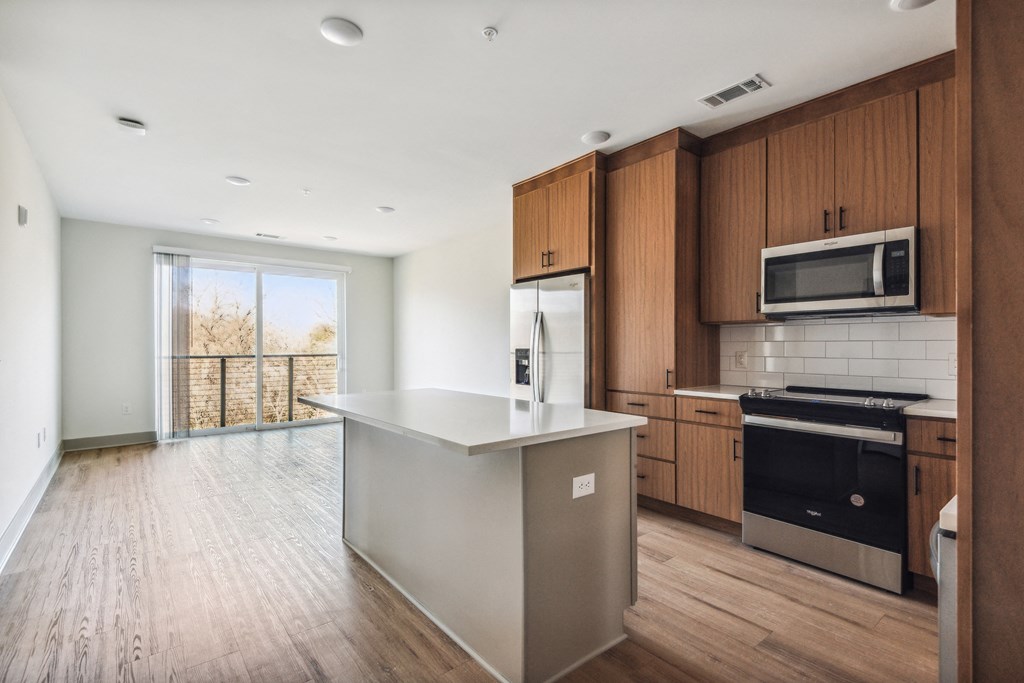 an empty kitchen with a large island in the middle