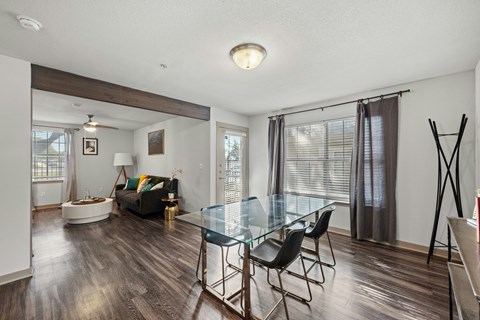 A living room with a glass table and chairs.