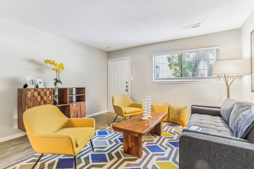 a living room with yellow chairs and a couch