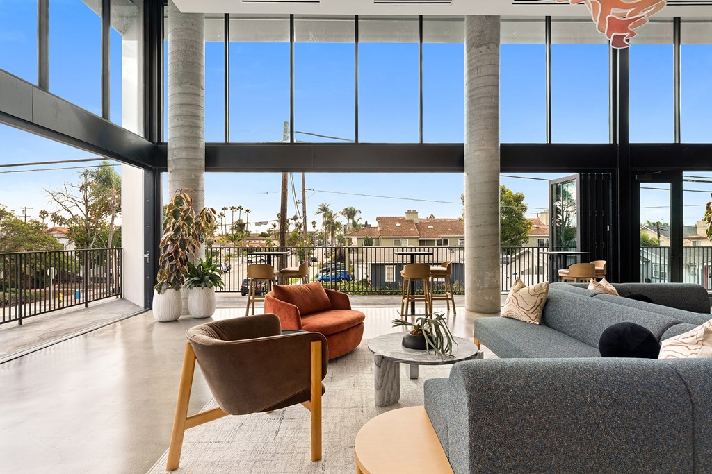 A modern living room with a large window and a view of the outdoors.