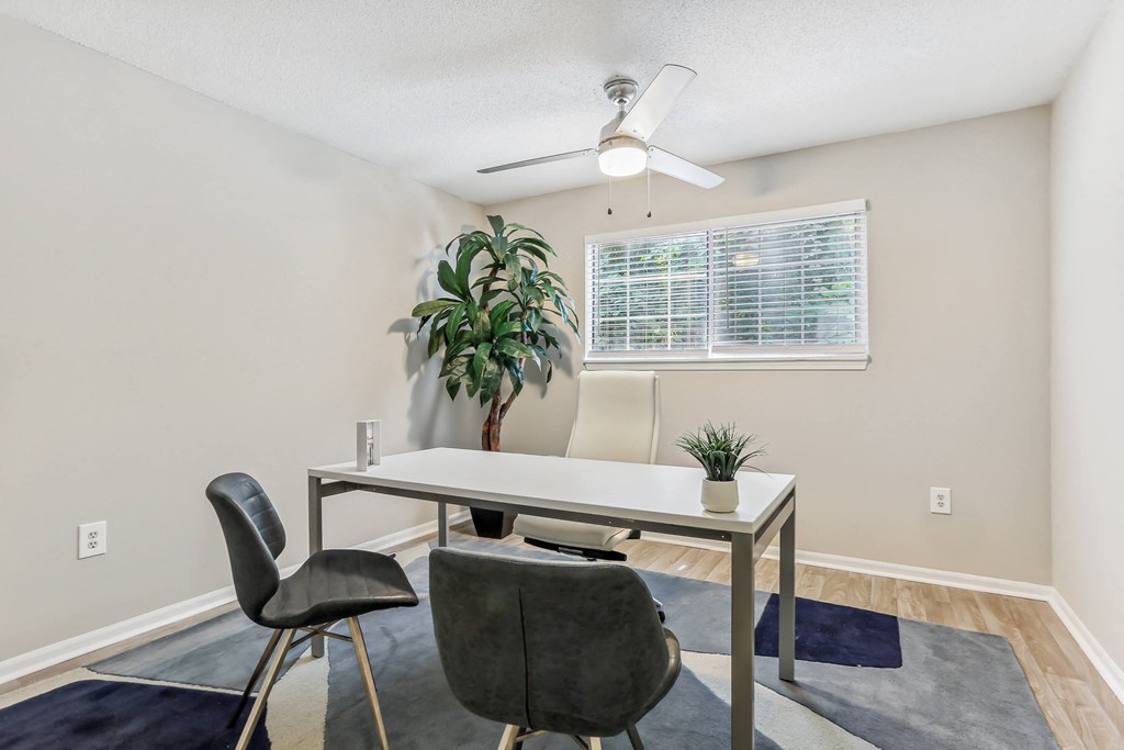 a dining room with a table and chairs