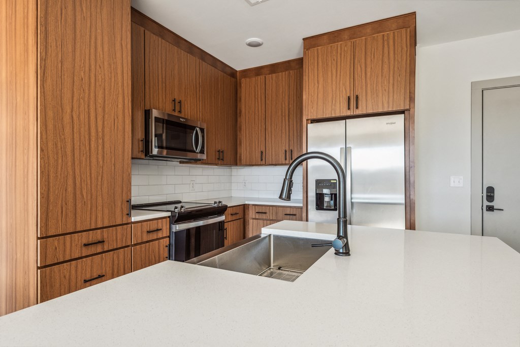 a kitchen with wooden cabinets and a sink