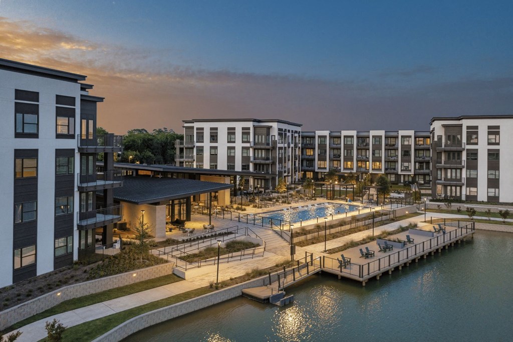 an aerial view of a resort with a pool and a dock