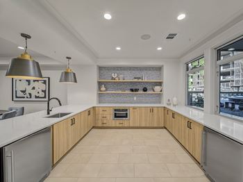 A modern kitchen with wooden cabinets and a large island.