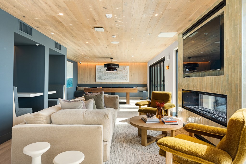 A living room with a yellow chair and a white table.