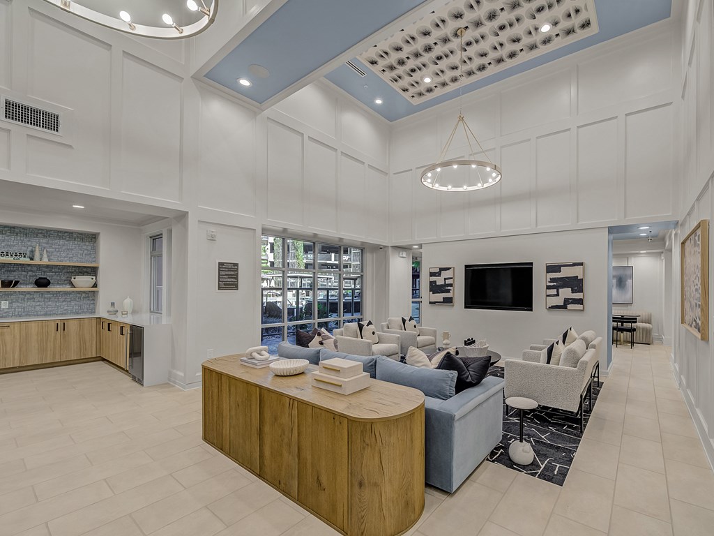 A modern living room with a wooden coffee table and a blue sofa.
