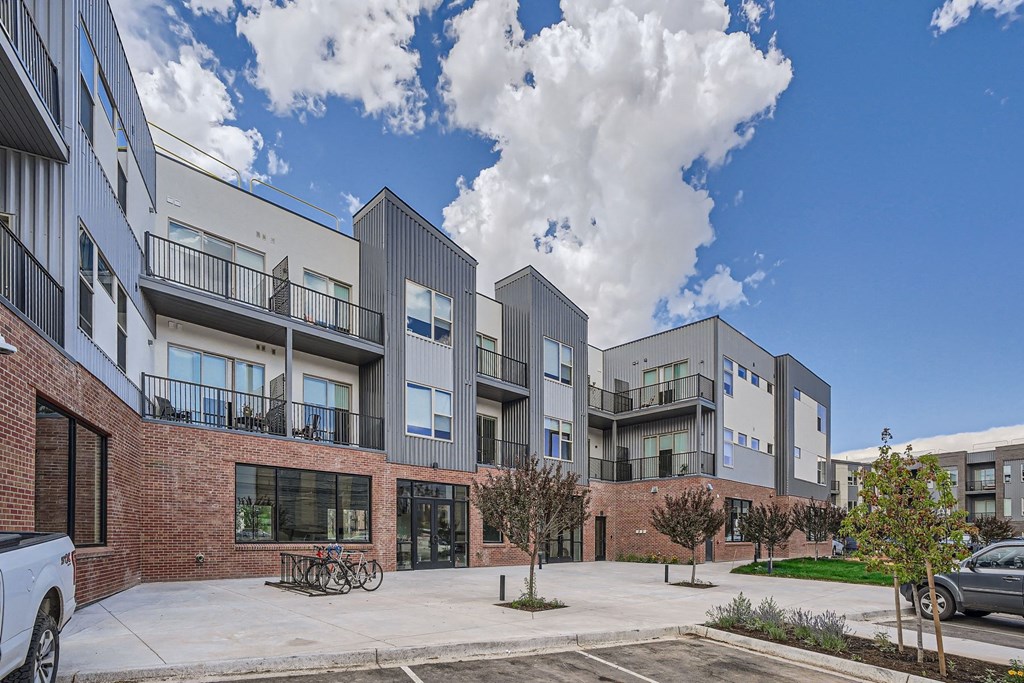 a picture of an apartment complex with a blue sky in the background