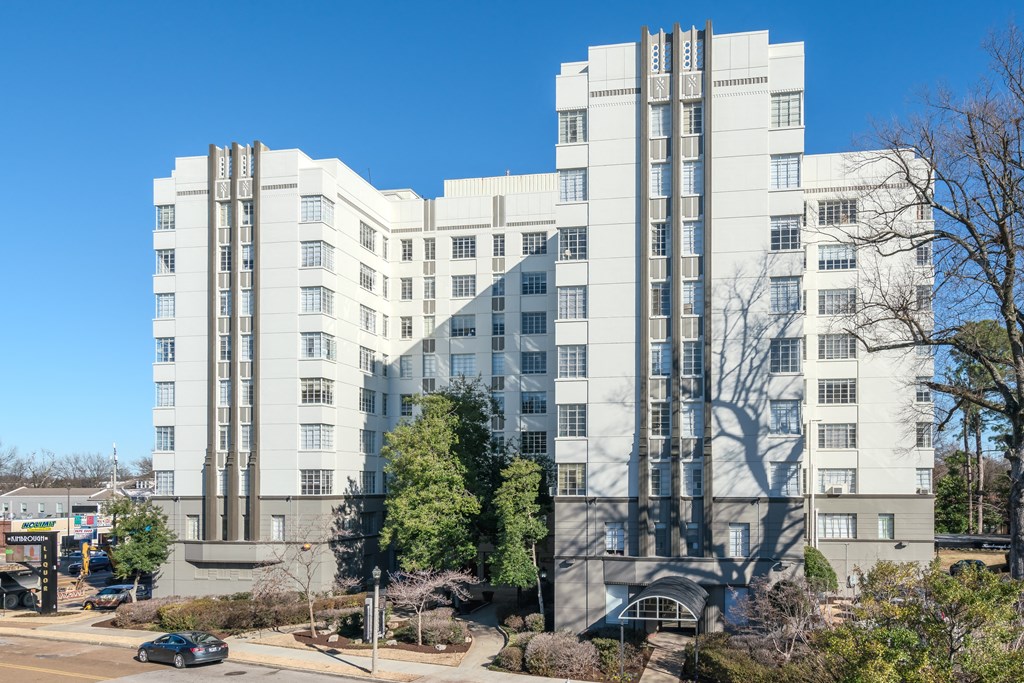 a large white building with a street in front of it