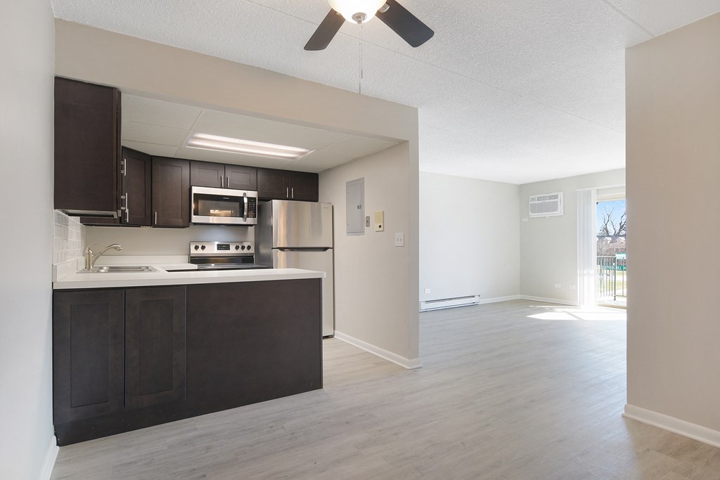 an empty kitchen and living room with a large window