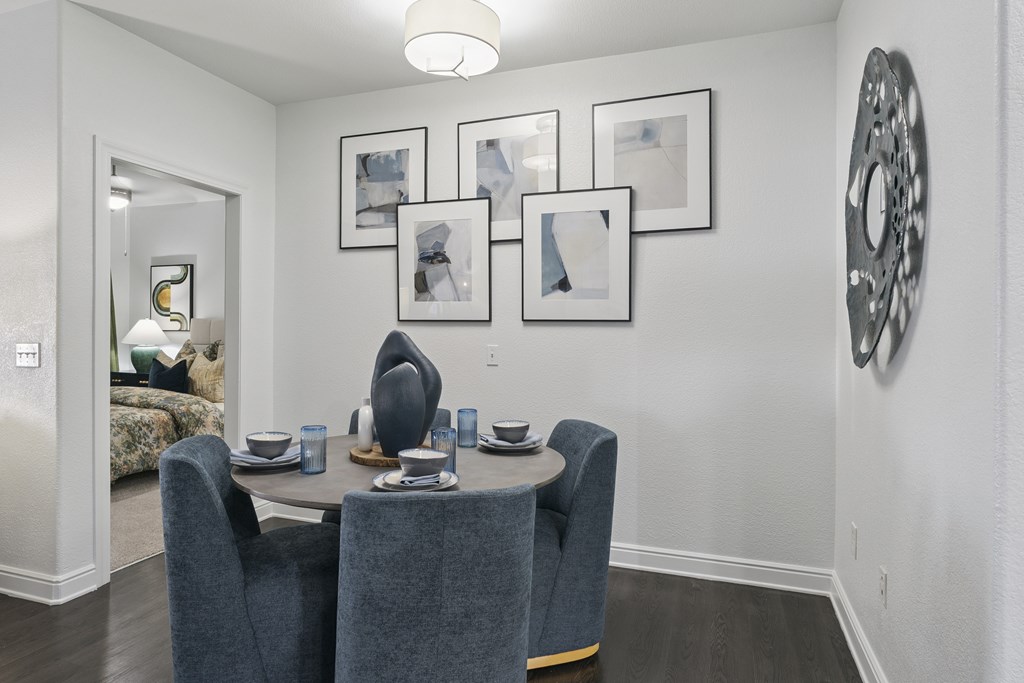 A dining room with a table set for four.