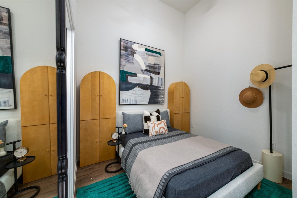 a bedroom with a bed and a mirror