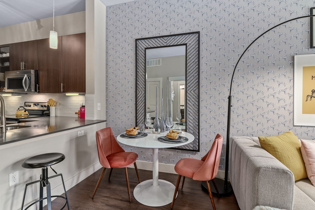 A modern kitchen with a dining table and chairs.