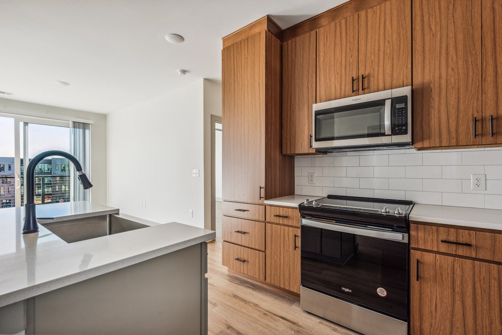 a kitchen with wooden cabinets and stainless steel appliances