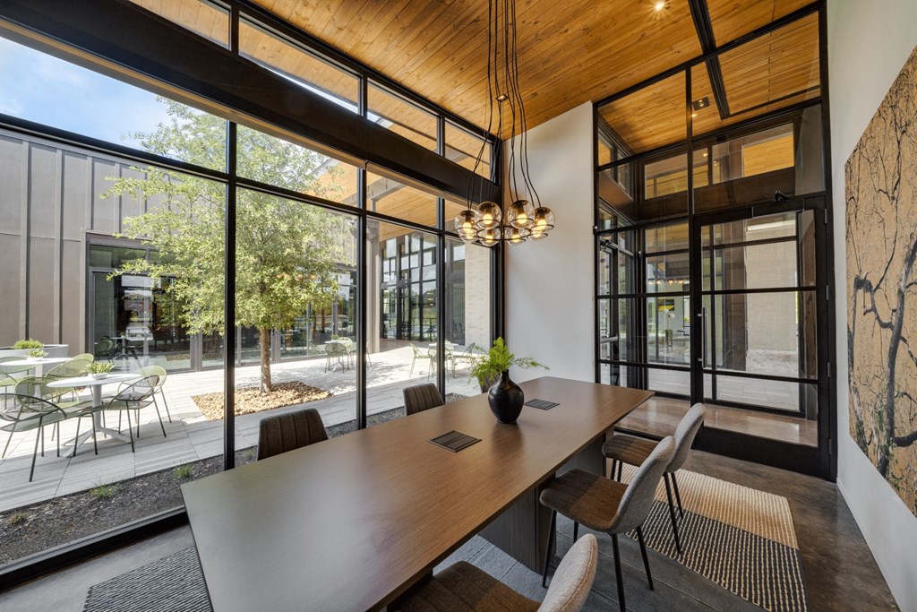 a conference room with large windows and a wooden ceiling