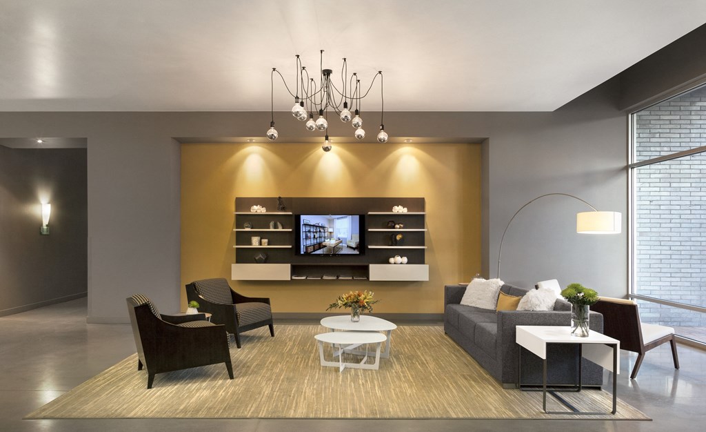 a living room with a couch and chairs and a television