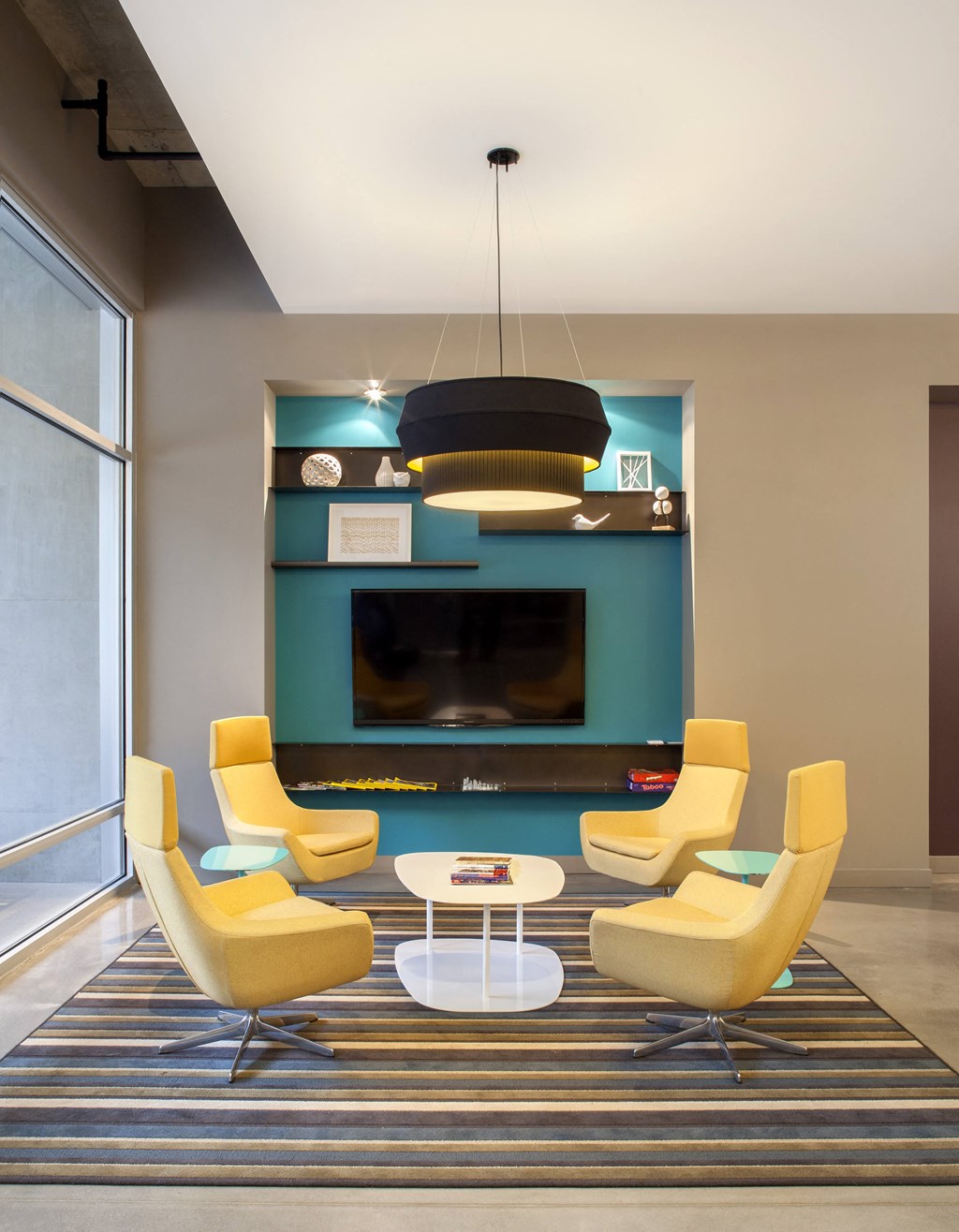 a living room with yellow chairs and a television