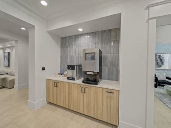 A modern kitchen with a wooden counter and a coffee machine.