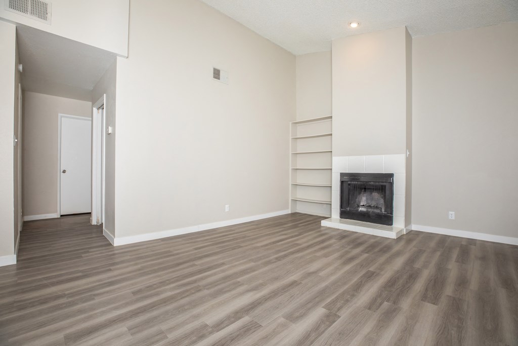 a living room with a fireplace and a bookshelf