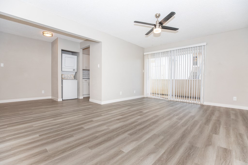 a living room with a ceiling fan and a window