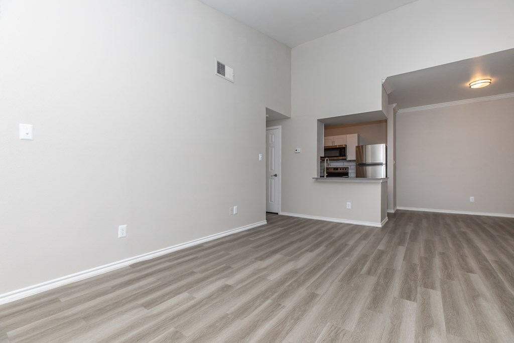 a bedroom with hardwood flooring at the whispering winds apartments in pearland, tx