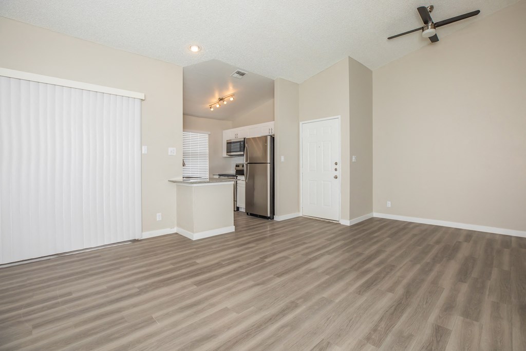 a living room with a kitchen in the background