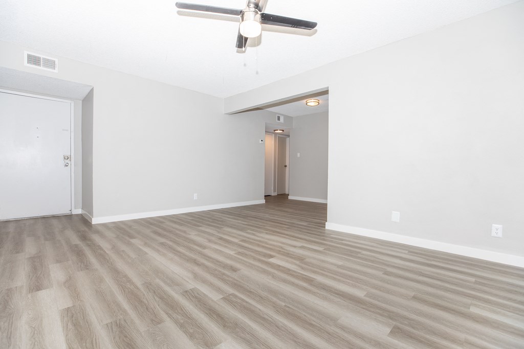 a bedroom with a ceiling fan and hardwood floors