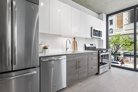 a kitchen with stainless steel appliances and a large window