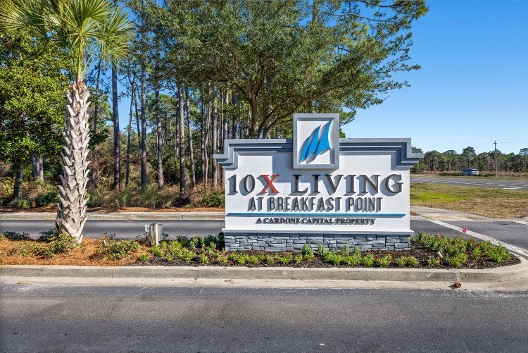 the sign at the entrance to the 101 living at breakfast point sign