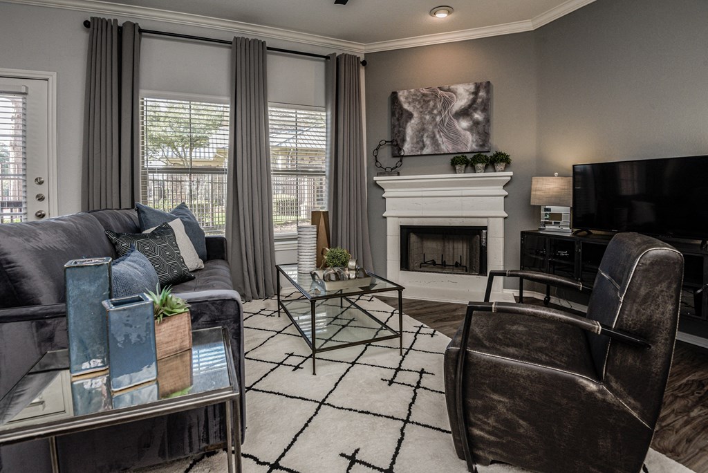 a living room with a couch and chairs and a fireplace