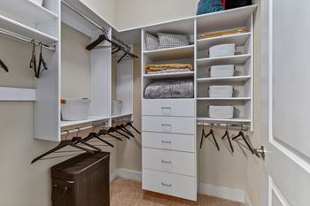 A white closet with drawers and shelves.