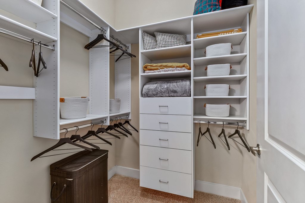 A white closet with drawers and shelves.