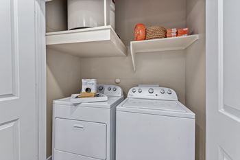 A small laundry room with a washer and dryer.