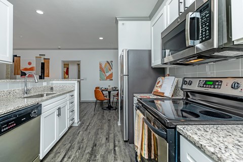 a kitchen with stainless steel appliances and white cabinets