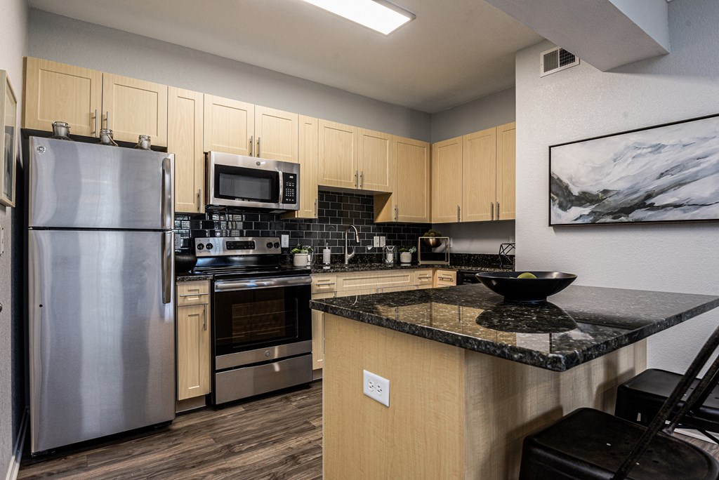 a kitchen with stainless steel appliances and granite counter tops