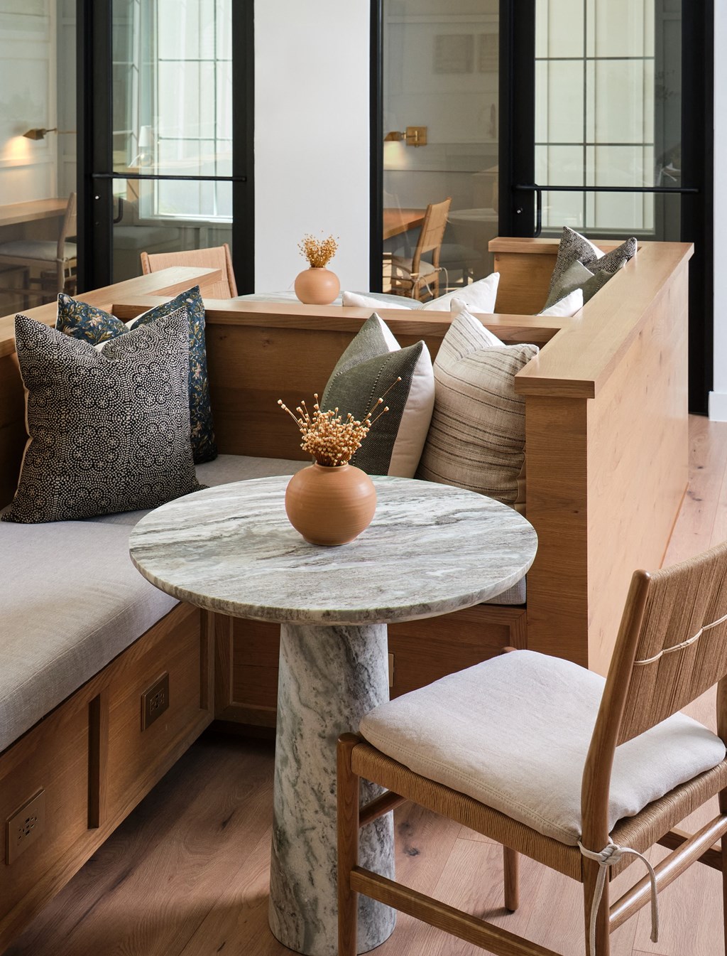 A round marble table with a single orange ball on it.