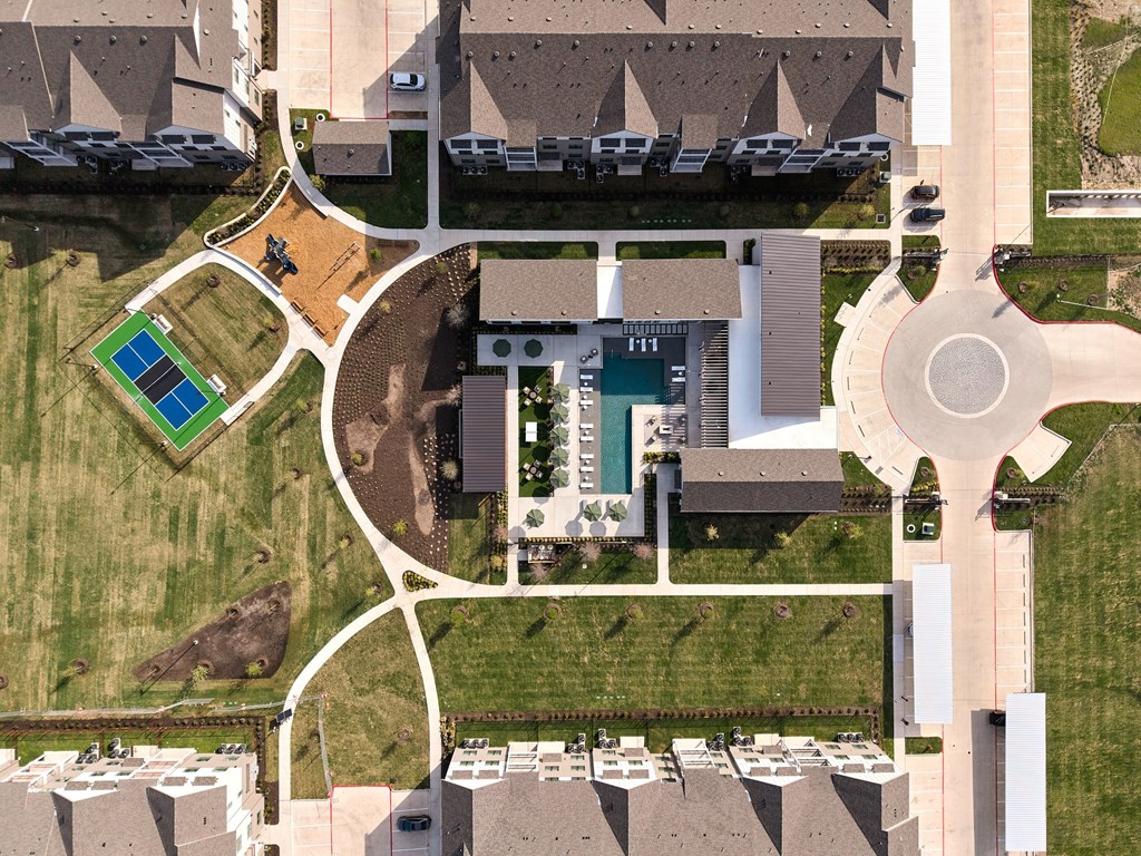 A bird's eye view of a residential area with a swimming pool and a building with the number 111 on it.