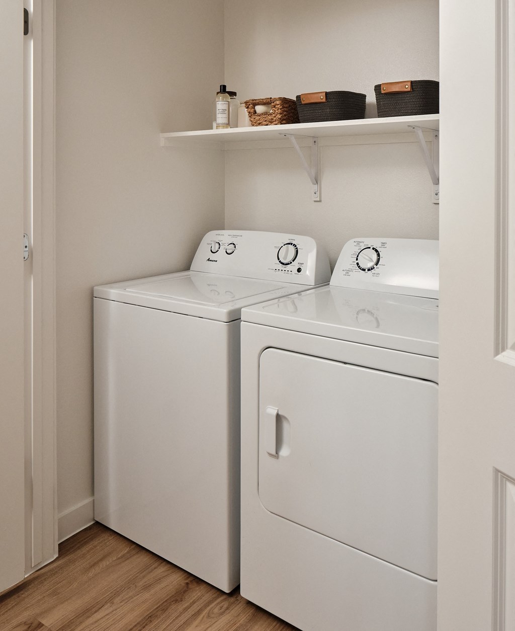 A white washing machine and dryer in a small laundry room.