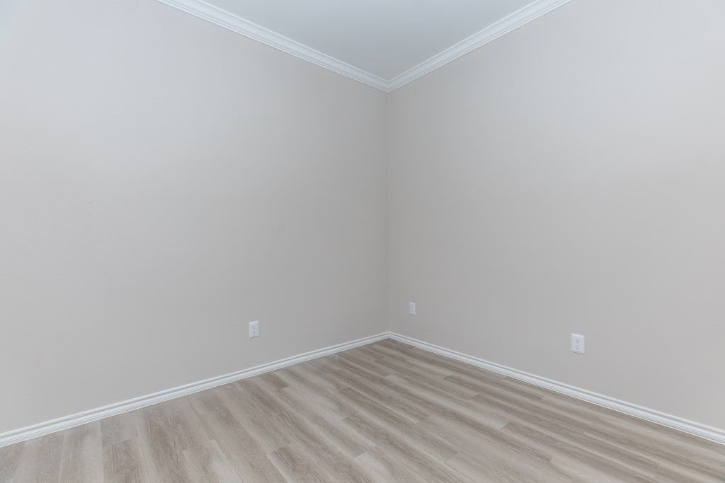 a room with gray walls and a wooden floor