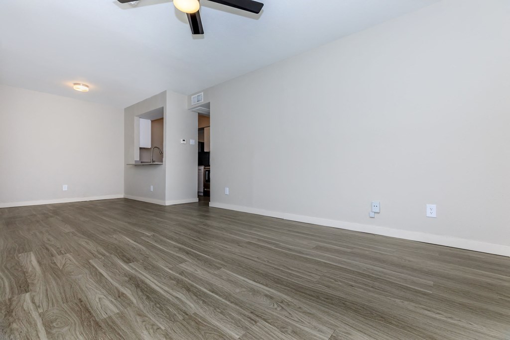 a bedroom with a ceiling fan and hardwood floors