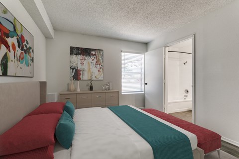 a bedroom with a bed and a door to a bathroom