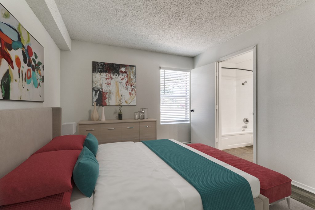 a bedroom with a bed and a door to a bathroom