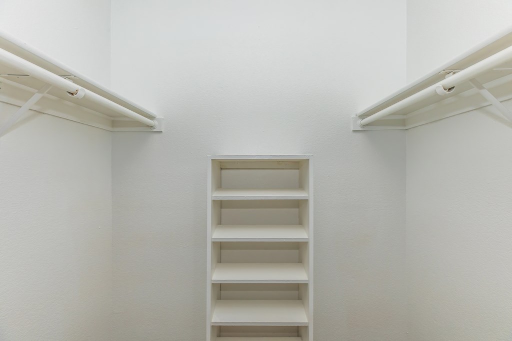 a white room with a ladder in the middle of the wall