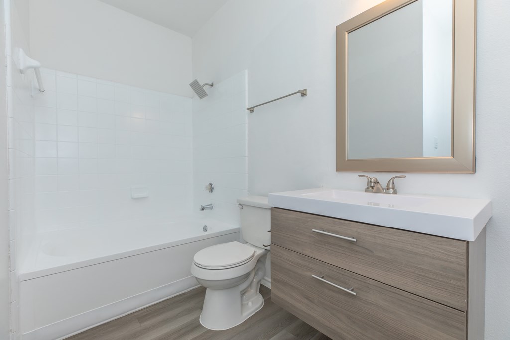 a bathroom with a toilet sink and bathtub in a 555 waverly unit